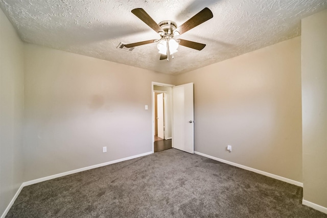 unfurnished room with dark colored carpet, ceiling fan, and a textured ceiling