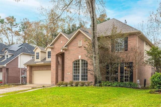 view of front property featuring a garage and a front lawn