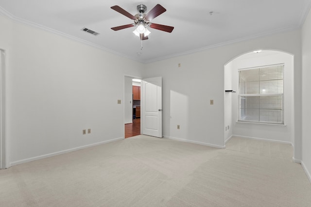 carpeted spare room featuring ornamental molding and ceiling fan