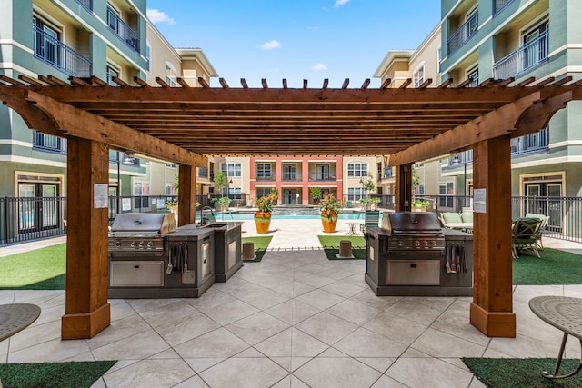 view of patio / terrace with area for grilling, a grill, and a pergola