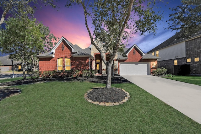 view of front of property with a garage and a yard