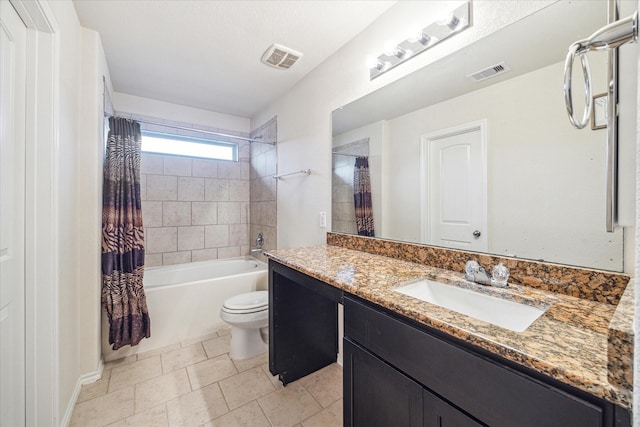 full bathroom featuring tile patterned floors, vanity, toilet, and shower / bath combo with shower curtain