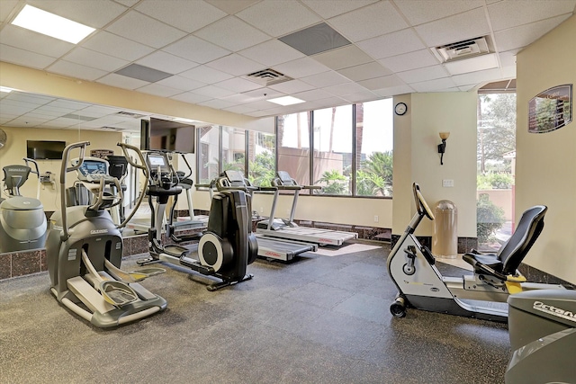 gym with a paneled ceiling