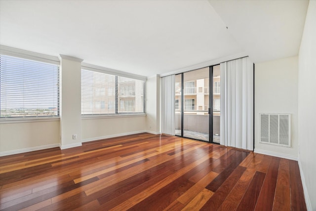 spare room with dark hardwood / wood-style floors