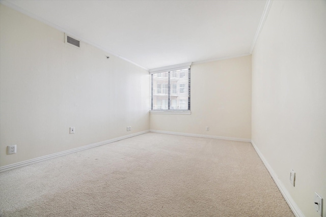 spare room featuring light carpet and ornamental molding