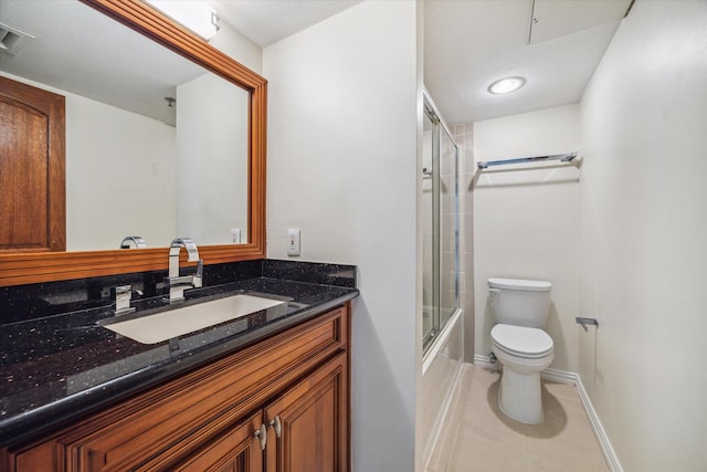 full bathroom featuring tile patterned flooring, vanity, enclosed tub / shower combo, and toilet