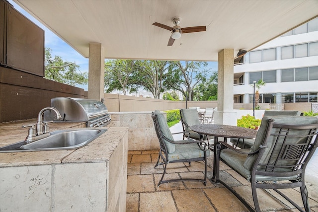 view of patio featuring area for grilling, an outdoor kitchen, sink, and ceiling fan