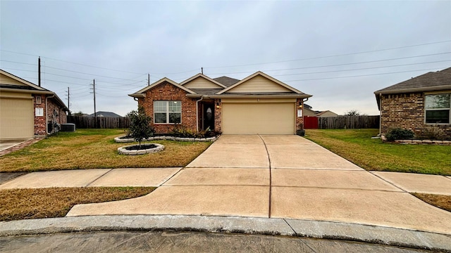 view of front of property with a garage, a front yard, and central air condition unit