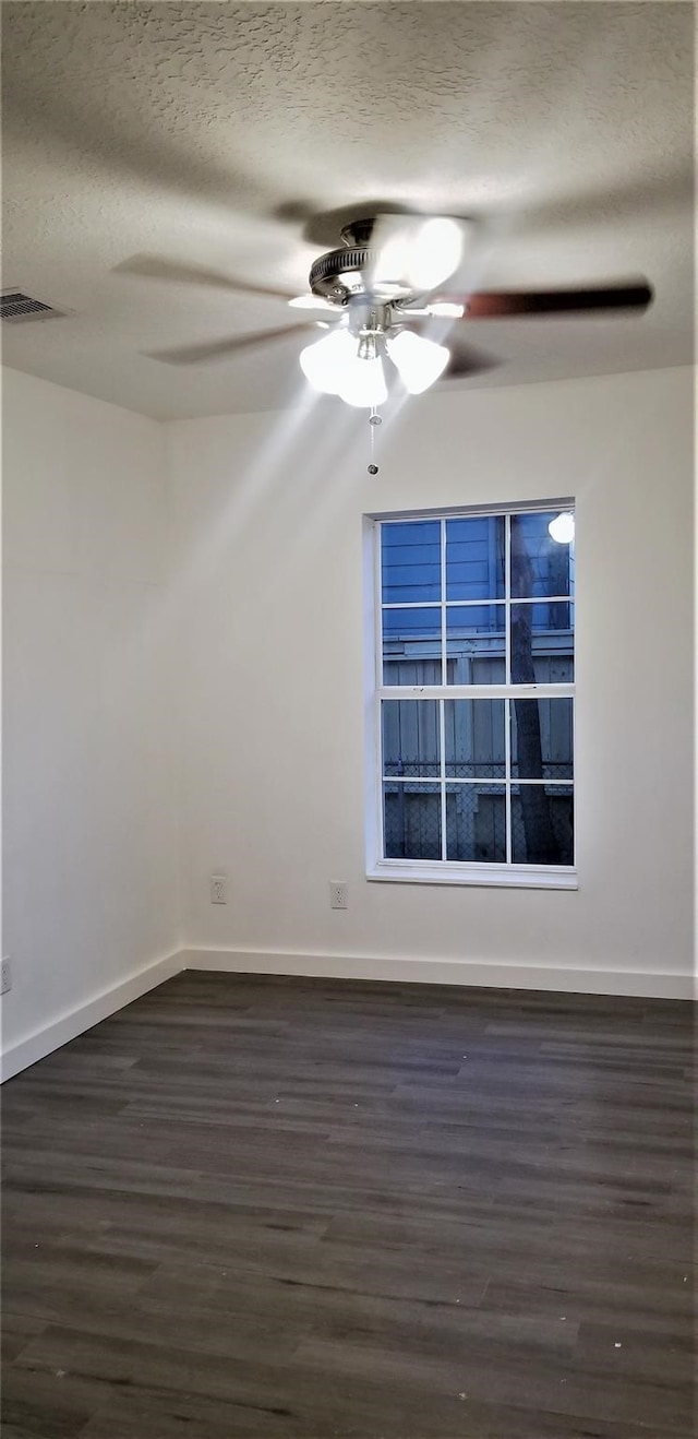 unfurnished room featuring ceiling fan, dark hardwood / wood-style floors, and a textured ceiling