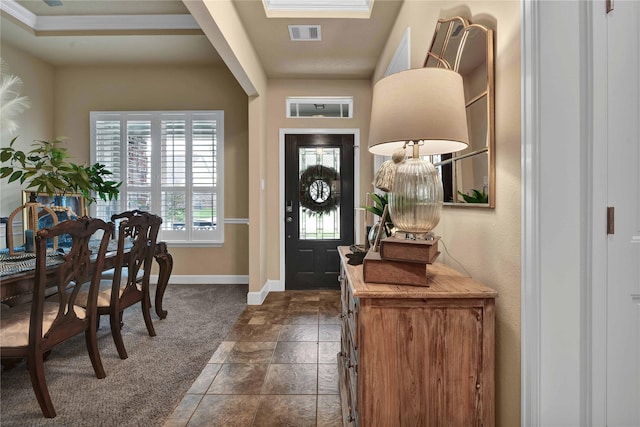 view of carpeted foyer entrance