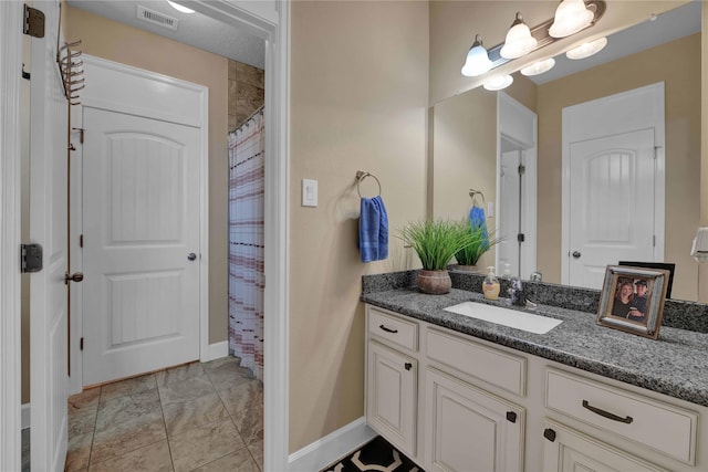 bathroom featuring vanity and curtained shower