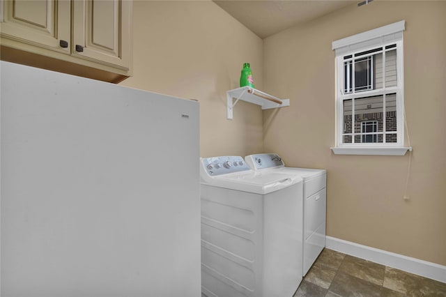 laundry area featuring cabinets and independent washer and dryer