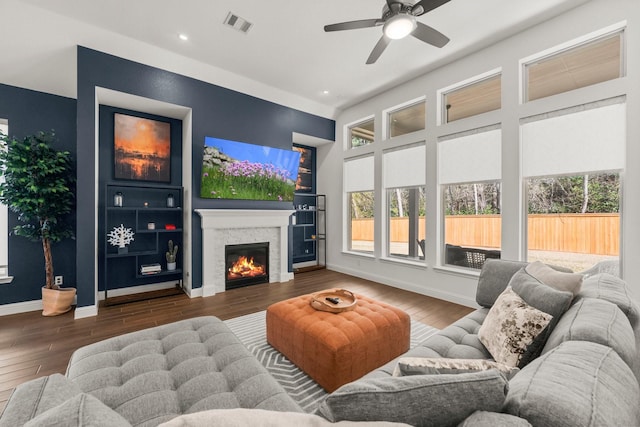 living room with dark wood-type flooring and ceiling fan