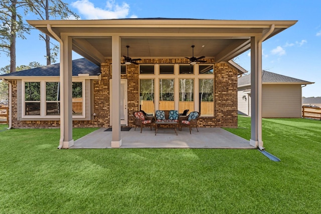 rear view of house featuring ceiling fan, an outdoor hangout area, a patio, and a lawn