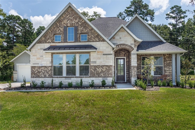 view of front of home featuring a garage and a front lawn