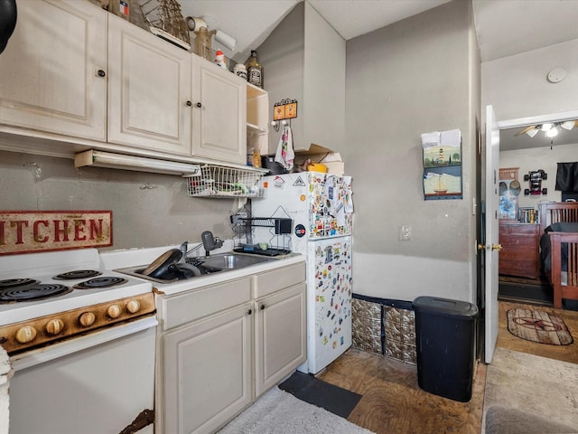 kitchen featuring white appliances, a sink, wood finished floors, light countertops, and open shelves