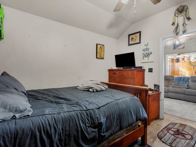 carpeted bedroom featuring lofted ceiling and ceiling fan