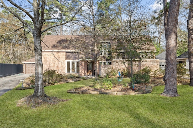 view of front of home with a garage and a front lawn