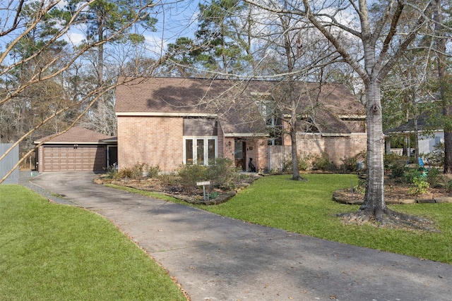 view of front of house with a garage and a front lawn