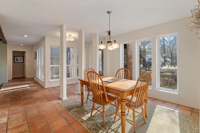 tiled dining space featuring a textured ceiling