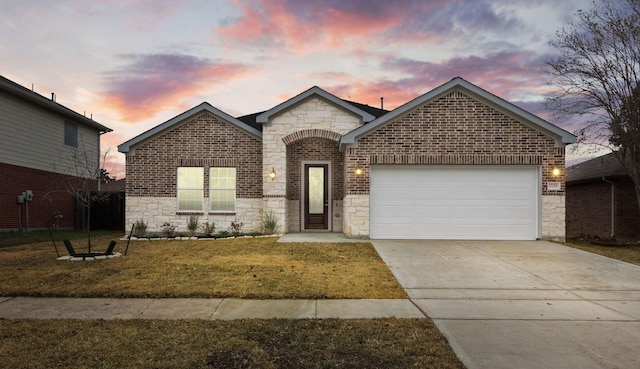 front facade with a garage and a lawn