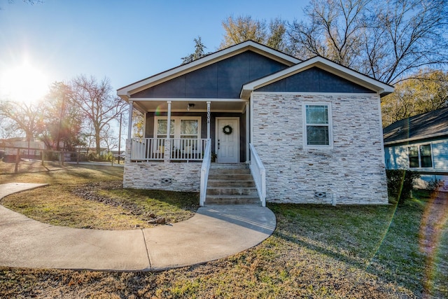 view of front of property with a front yard and a porch