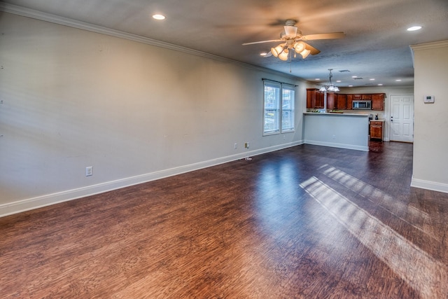 unfurnished living room featuring ornamental molding, dark hardwood / wood-style floors, and ceiling fan with notable chandelier