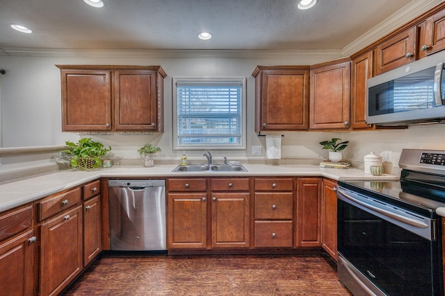 kitchen with sink, ornamental molding, stainless steel appliances, and dark hardwood / wood-style floors