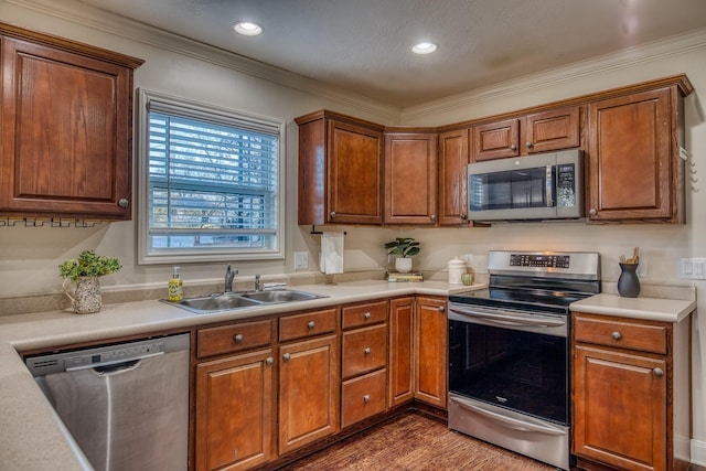 kitchen with sink, crown molding, stainless steel appliances, and dark hardwood / wood-style floors