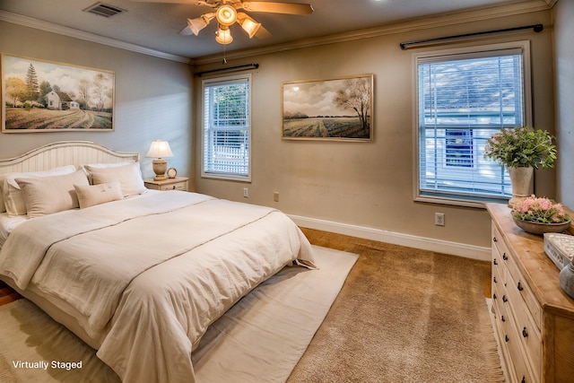 carpeted bedroom featuring multiple windows, crown molding, and ceiling fan