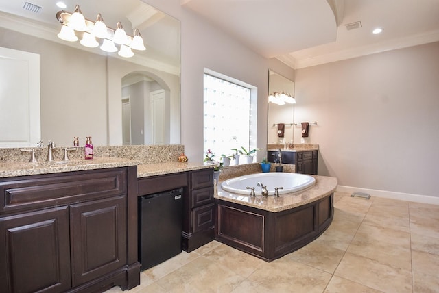 bathroom featuring crown molding, tile patterned floors, vanity, and a tub to relax in