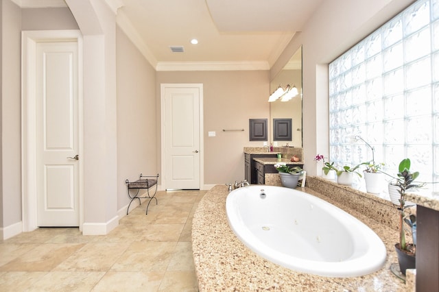 bathroom featuring vanity, a tub, and ornamental molding