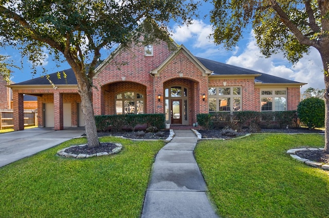 view of front facade featuring a front lawn, an attached garage, brick siding, and driveway