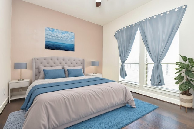 bedroom featuring baseboards and wood finished floors