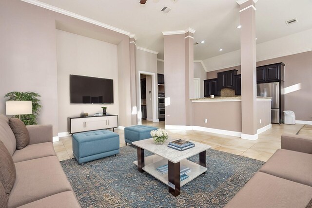 living room featuring visible vents, crown molding, baseboards, light tile patterned floors, and ornate columns