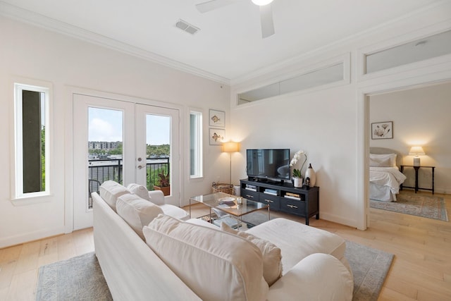 living room with french doors, ceiling fan, crown molding, and light hardwood / wood-style flooring