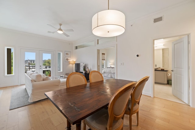 dining room featuring light hardwood / wood-style flooring, ornamental molding, french doors, and ceiling fan