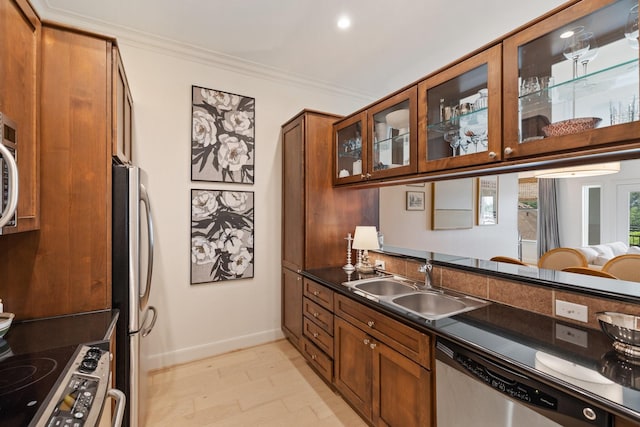 kitchen with sink, crown molding, and appliances with stainless steel finishes