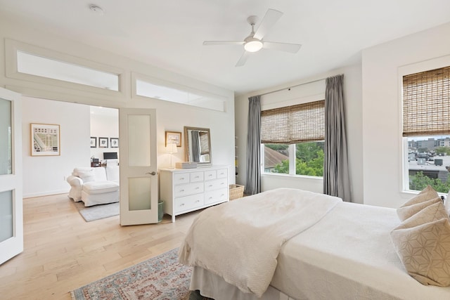 bedroom with light wood-type flooring and ceiling fan