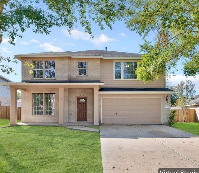 view of front of property with a garage and a front lawn