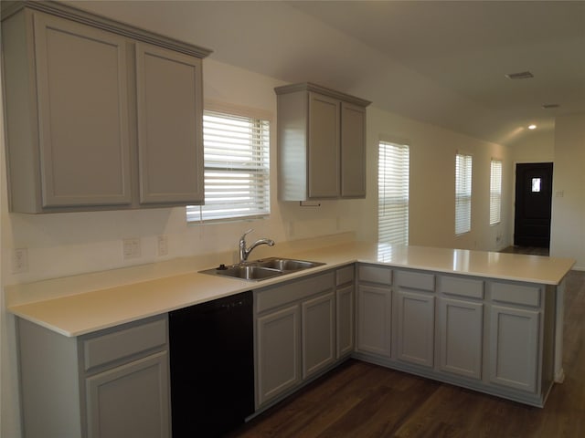 kitchen featuring a peninsula, gray cabinets, dishwasher, a sink, and dark wood-style flooring