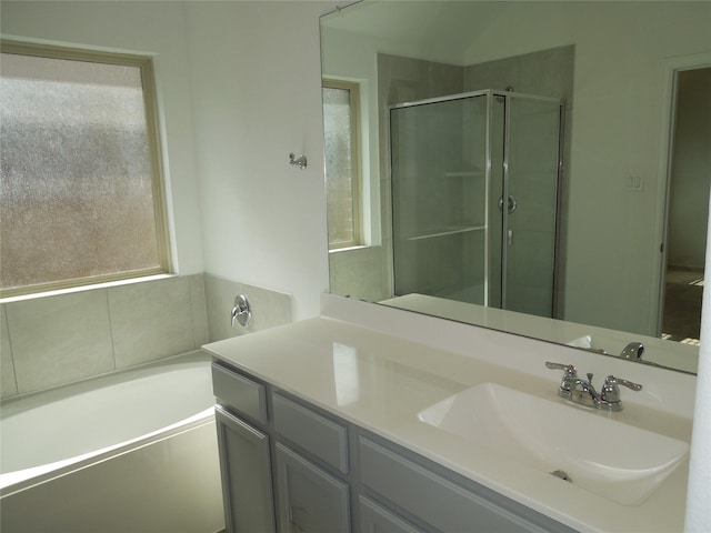 bathroom featuring vanity, a garden tub, and a stall shower