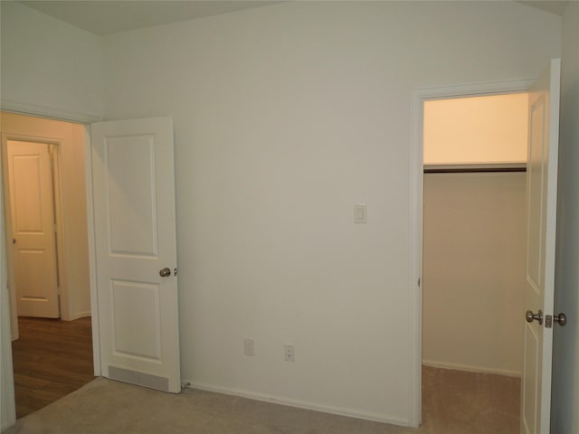 unfurnished bedroom with a closet, baseboards, and carpet floors