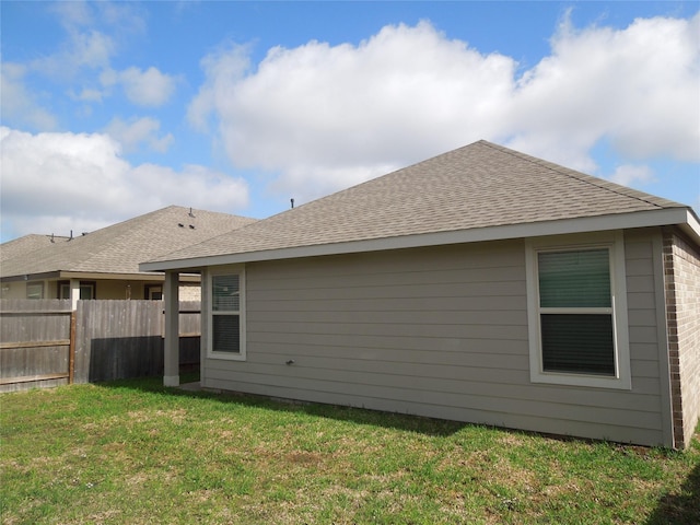 back of property featuring a yard