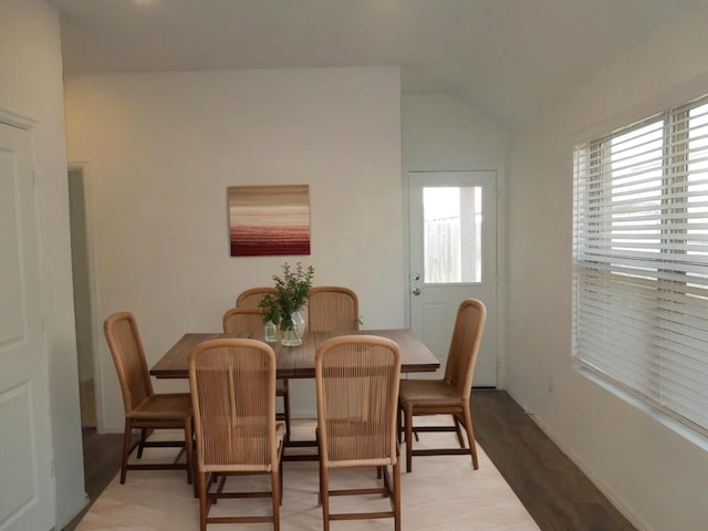 dining space with lofted ceiling and a healthy amount of sunlight