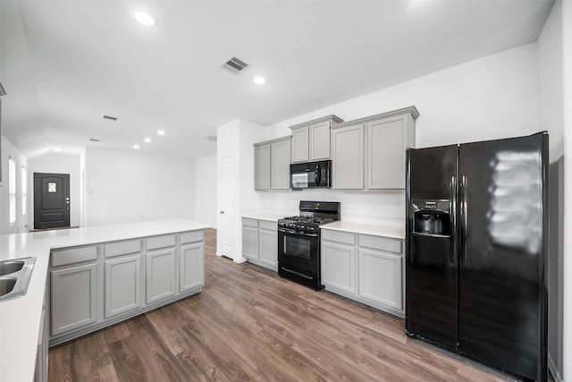 18415 Running Shadow Ct, Hockley, TX 77447 - kitchen featuring black appliances, gray cabinetry, dark wood-style flooring, light countertops, and recessed lighting