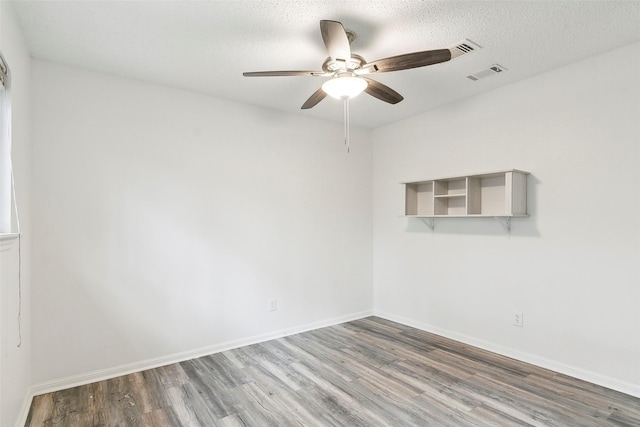 empty room featuring hardwood / wood-style floors, a textured ceiling, and ceiling fan