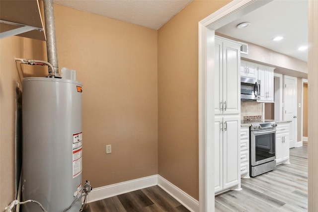 utility room with gas water heater