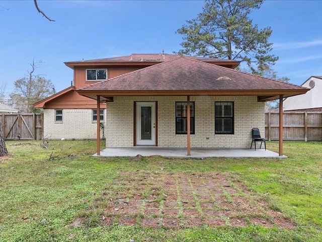 back of property featuring a yard and a patio