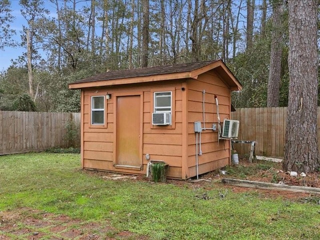 view of outdoor structure featuring a yard and cooling unit